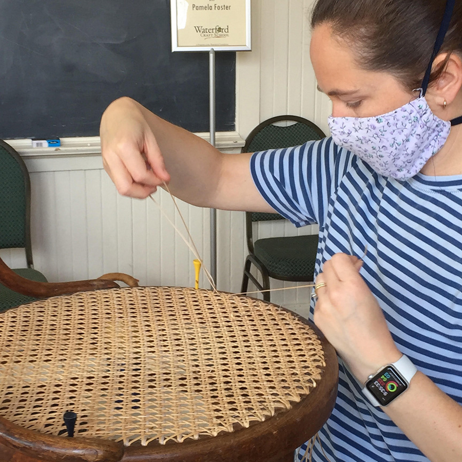 Student learning traditional caning techniques at the Craft School.